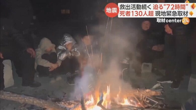 たき火で暖をとる人たちの姿も見られた