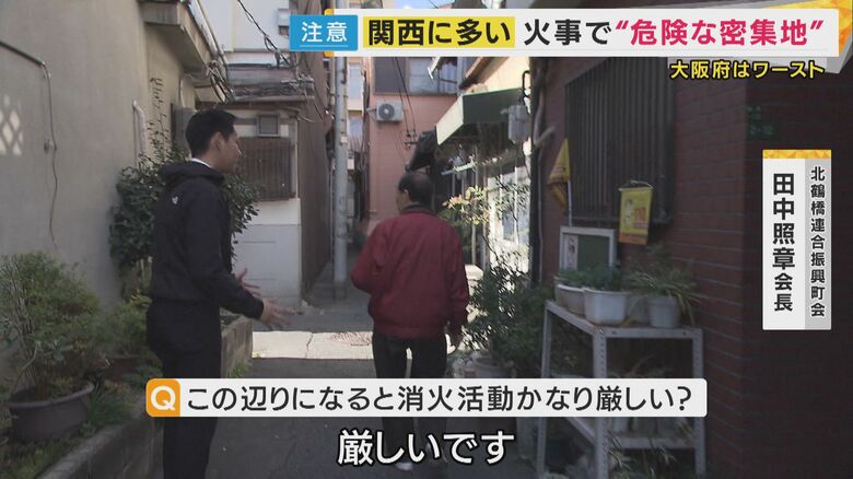 町内会長と共に住宅密集地を歩く記者