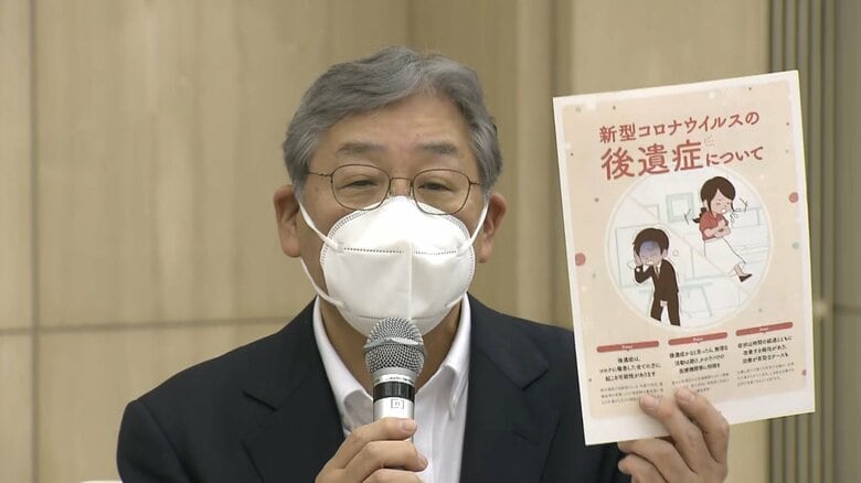 記者会見で、賀来氏は、新たに作ったコロナ後遺症のリーフレットについて説明した。