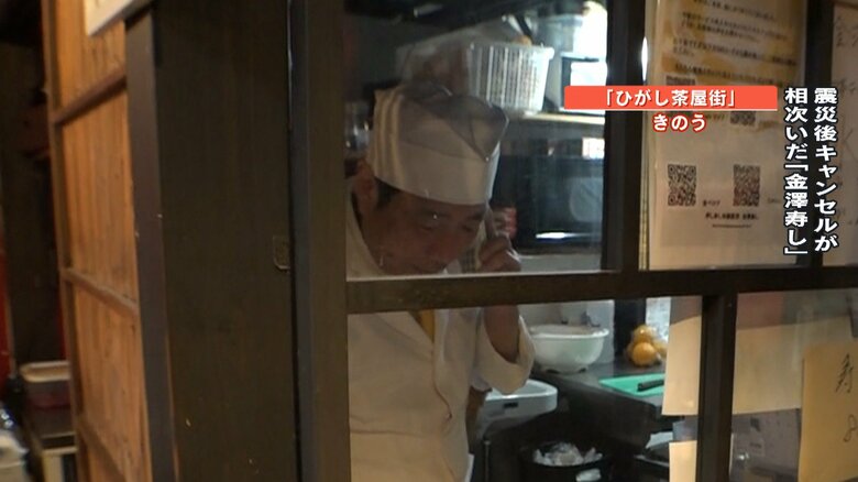 電話を受ける周田代表