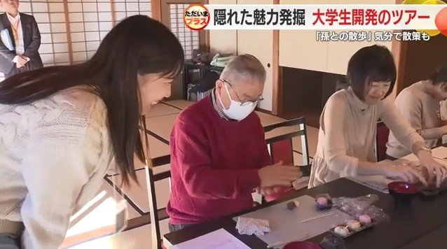 和菓子作り体験中の参加者と見守る学生