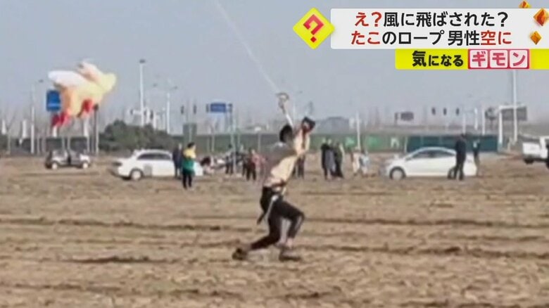 たこからピンと伸びたロープを滑車を使って滑り降り、着地する男性（画像：中国SNS）