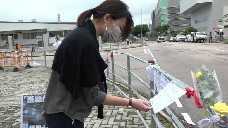 リンゴ日報に宛てた市民のメッセージを見るクワンさん