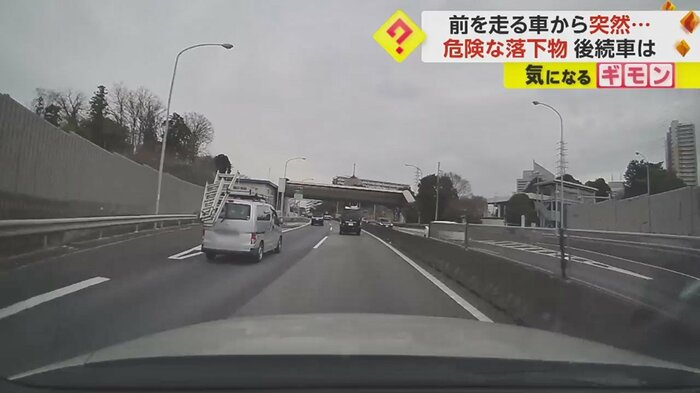 左の車線を走る車の荷台から脚立が…