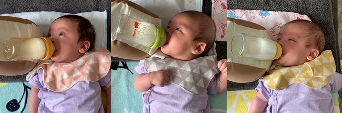 クッションを使って飲んでいる三つ子の表情アップ
