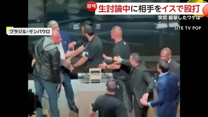 スタッフに制止される候補者