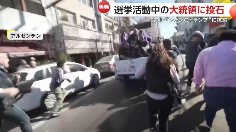 大統領を乗せた車を追いかけるデモ隊