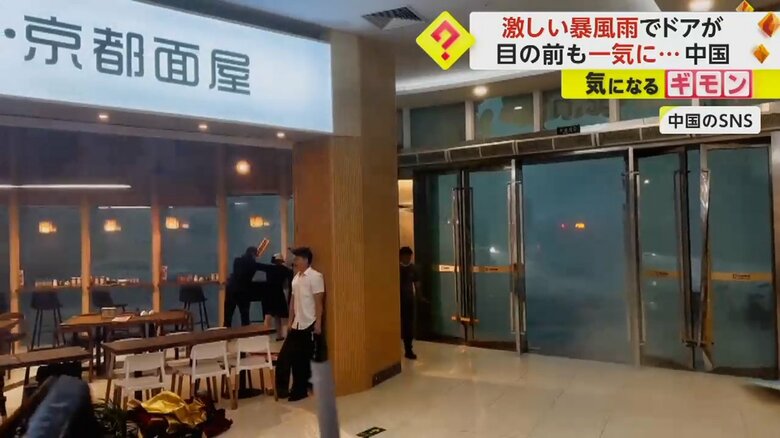 ショッピングモールのドアから風と雨が吹き込む