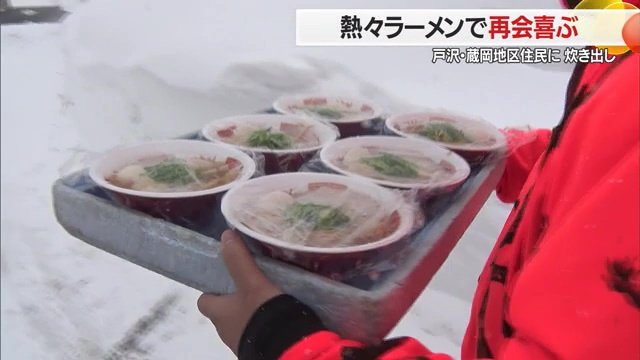 仮設住宅へラーメンを届けるスタッフ