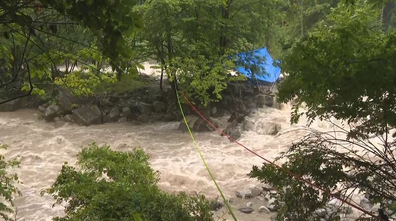 5人は歩いて川を渡り、中州でバーベキュー