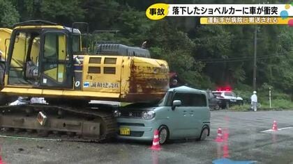 左折しようとしたトラックから積み荷のショベルカーが落下 対向車線を走っていた車に衝突し運転手を搬送