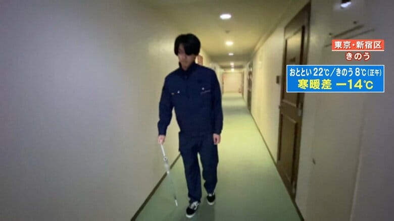 傘をつえ代わりにしながら、ゆっくりと歩く男性
