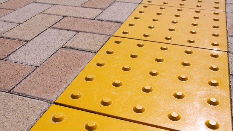 設置する「地面」管轄の違いで点字ブロックが途切れてしまうことがある（画像：イメージ）