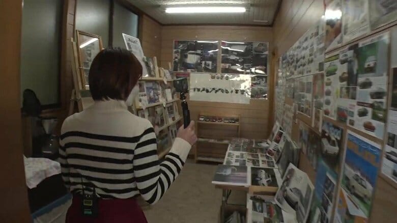 展示室への通路。車やオートバイのパンフレットが壁を埋め尽くす