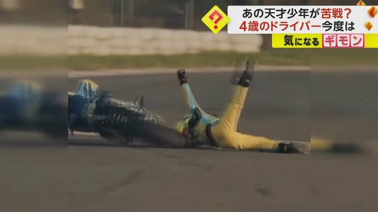 バイクから転げ落ちる男の子（IHA）