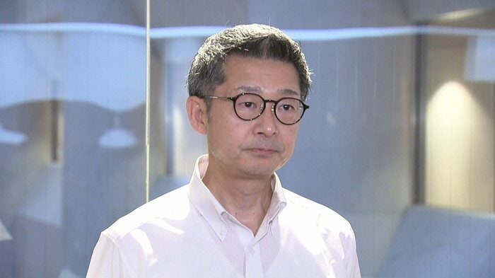 30日、取材に応じる松尾会長