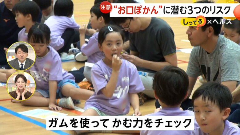 ガムを使って噛む力をチェックする参加者の子ども