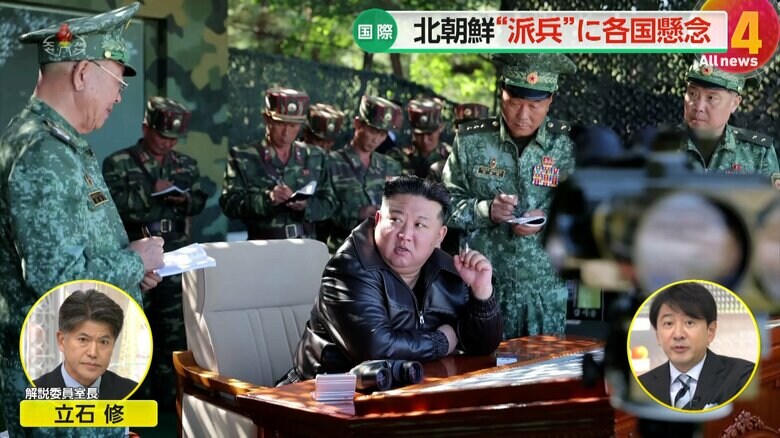 椅子に座り、軍服姿の人物と会話する北朝鮮の金正恩総書記