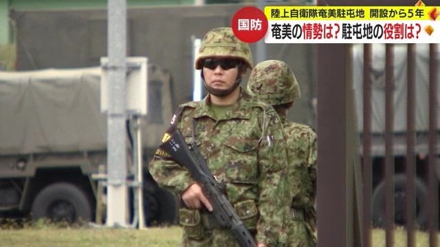 陸上自衛隊奄美駐屯地入り口で銃を持って警備をする隊員