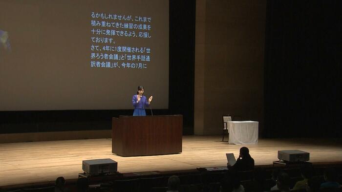 ステージ下にいる手話通訳者が読み取り通訳を行った