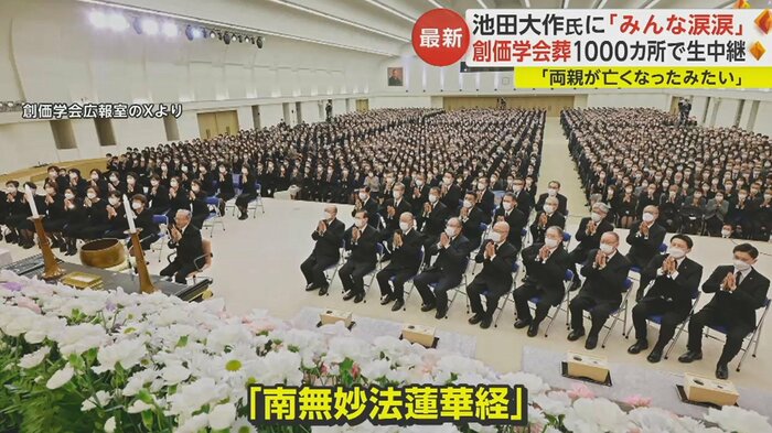 多くの学会員が手を合わせている