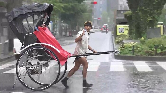 雨の中でも観光客を乗せて走る人力車