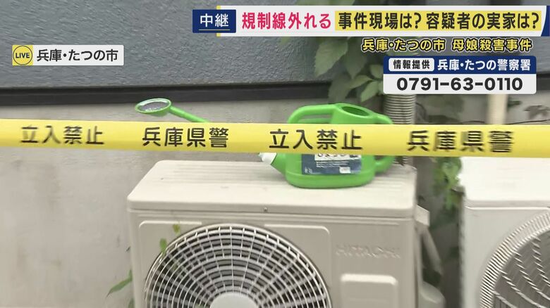 室外機の上のじょうろ