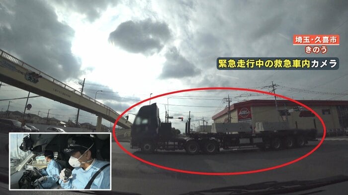 救急車の目の前を通過する大型トラック