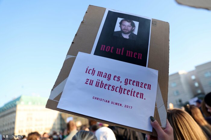 別の集会では夫のウルメン氏を抗議するプラカードも　2026年3月