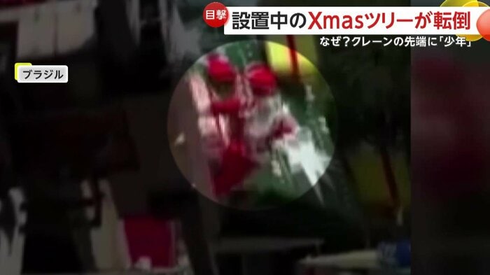 クレーンから脱出するサンタクロース姿の作業員（IHA）