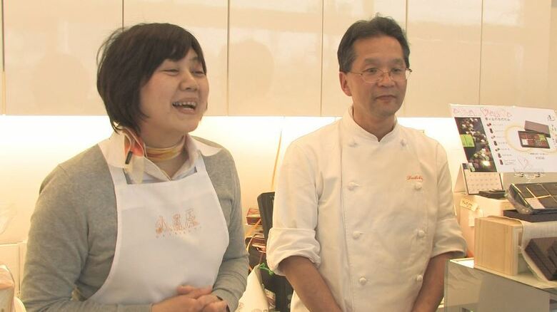 店頭に立つ伊丹さん夫妻（2011年取材）