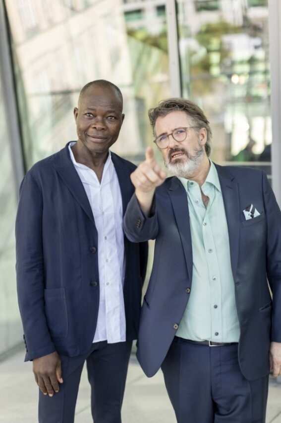 ベルリンで行われた世界文化賞記者発表会場で建築部門受賞者ディエベド・フランシス・ケレ（左）と写真に納まるオラファー・エリアソン（右）　Photo: Pablo Castagnola