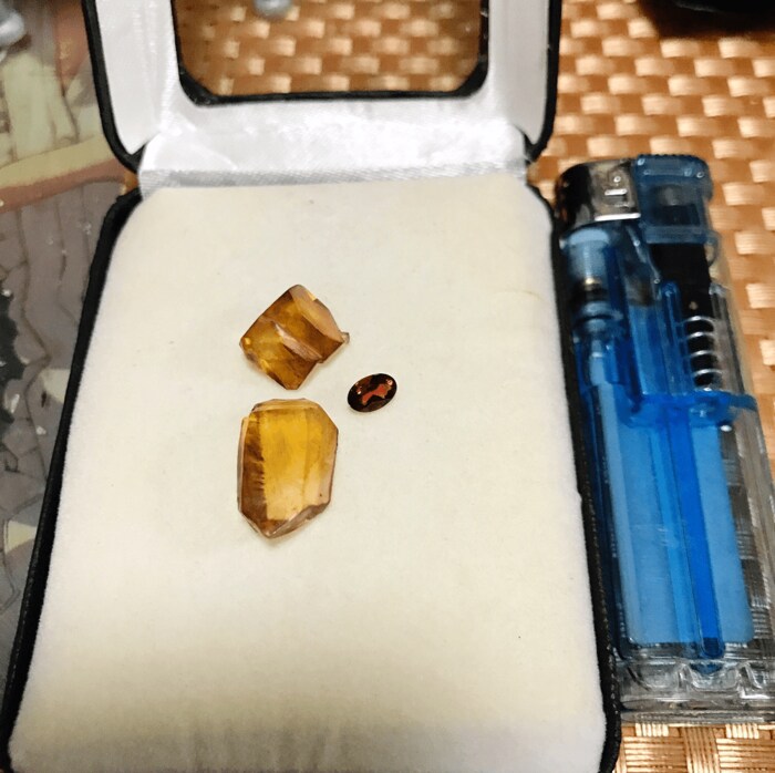 使い捨てライターと大きさを比較(楕円形の赤い石は0.51カラットのガーネット)