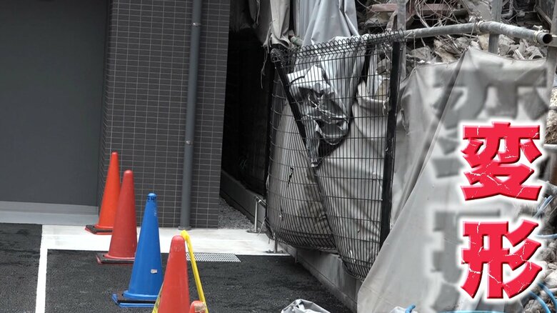 隣のマンションのフェンスは変形している