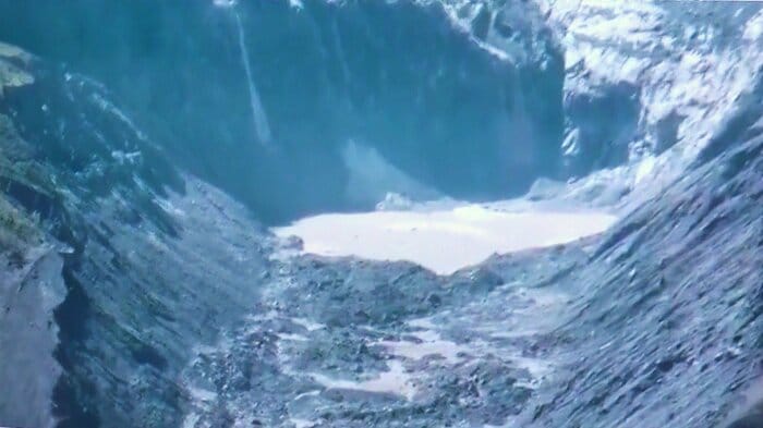 崩落後を捉えたドローン映像より。大量の岩石や土砂が堆積し、くぼ地には水がたまって湖が形成されている