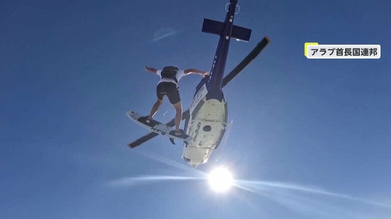 アラブ首長国連邦でサーフボードに乗ってスカイダイビングする男性