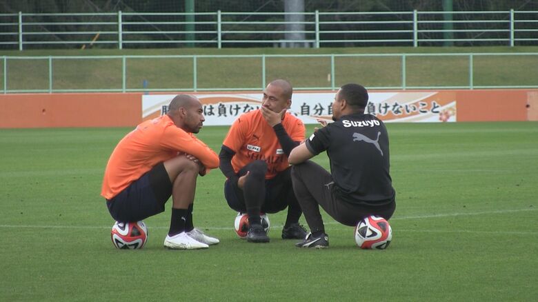 練習後に話し合うサンタナ選手（左）と吉田選手（中央）