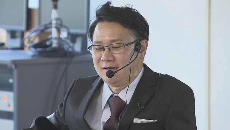 県庁で「トップキャプス」の説明をする堀内さん（7月9日）