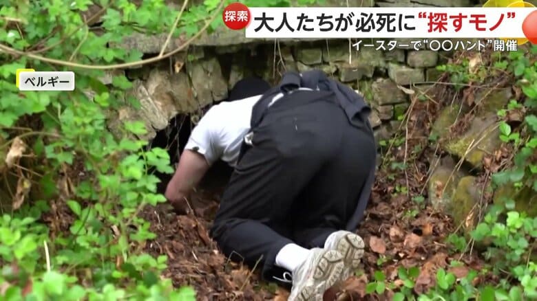 穴の中に頭を入れて探す人（Diego De Schuyter）