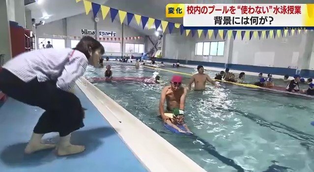 スイミングスクールでの授業を見守る教師（資料）