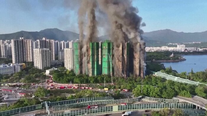黒煙を上げる香港の高層住宅（26日）