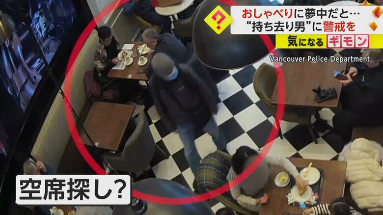 店の奥の方まで歩いて行く男