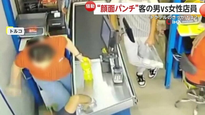 地面に落ちたお釣りを拾おうとかがんだ男