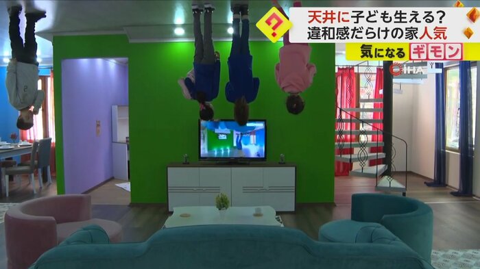 ソファが置かれたリビングで、子供たちが逆さまの状態でテレビを見ている