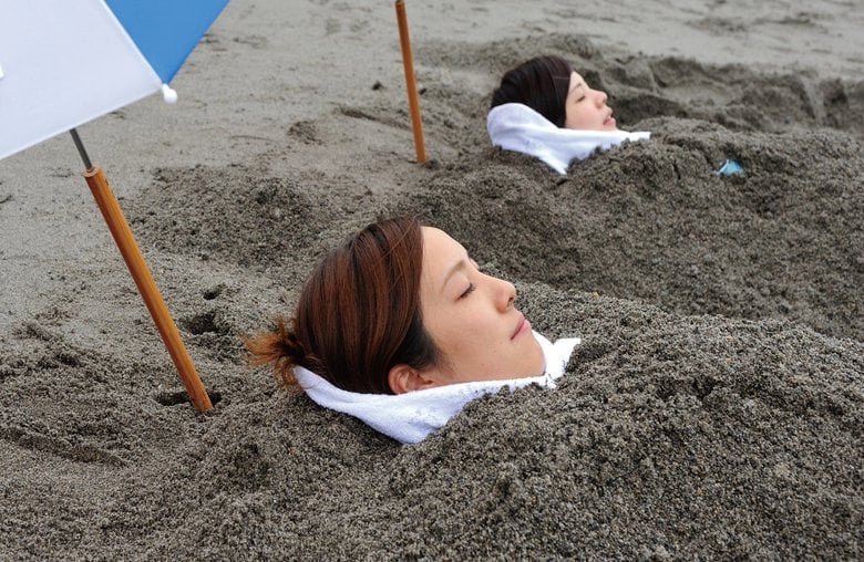 砂むし温泉を体験している様子