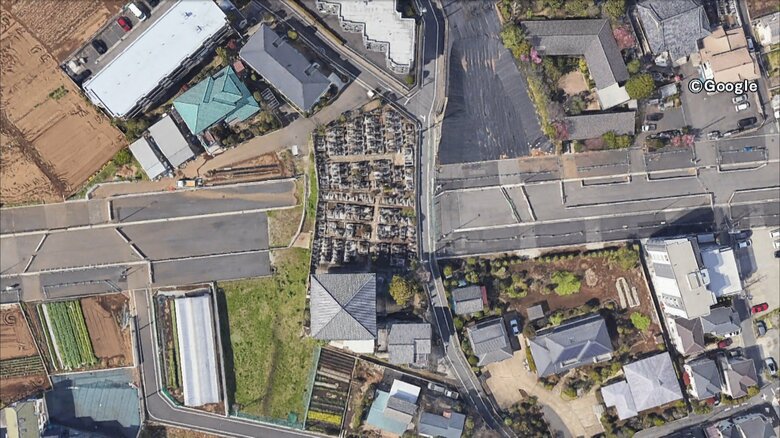 作られた道路を分断するように残ったお墓