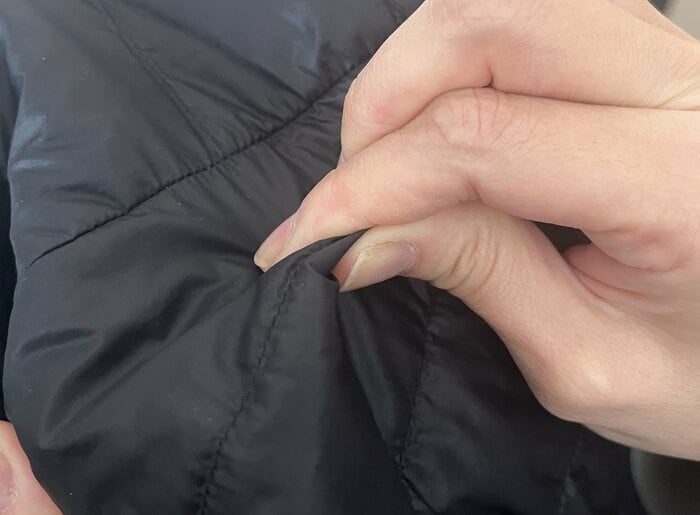 指で生地を揉むとフェザーは抜けにくくなる（特集班撮影）