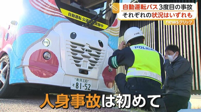 事故を起こしたバスと現場検証を行う警察官