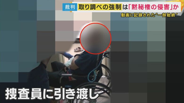 取調室へ連行される男性