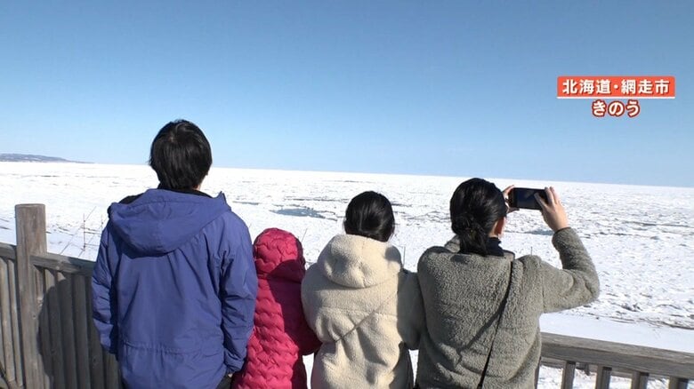 安全な場所から流氷を楽しむ観光客